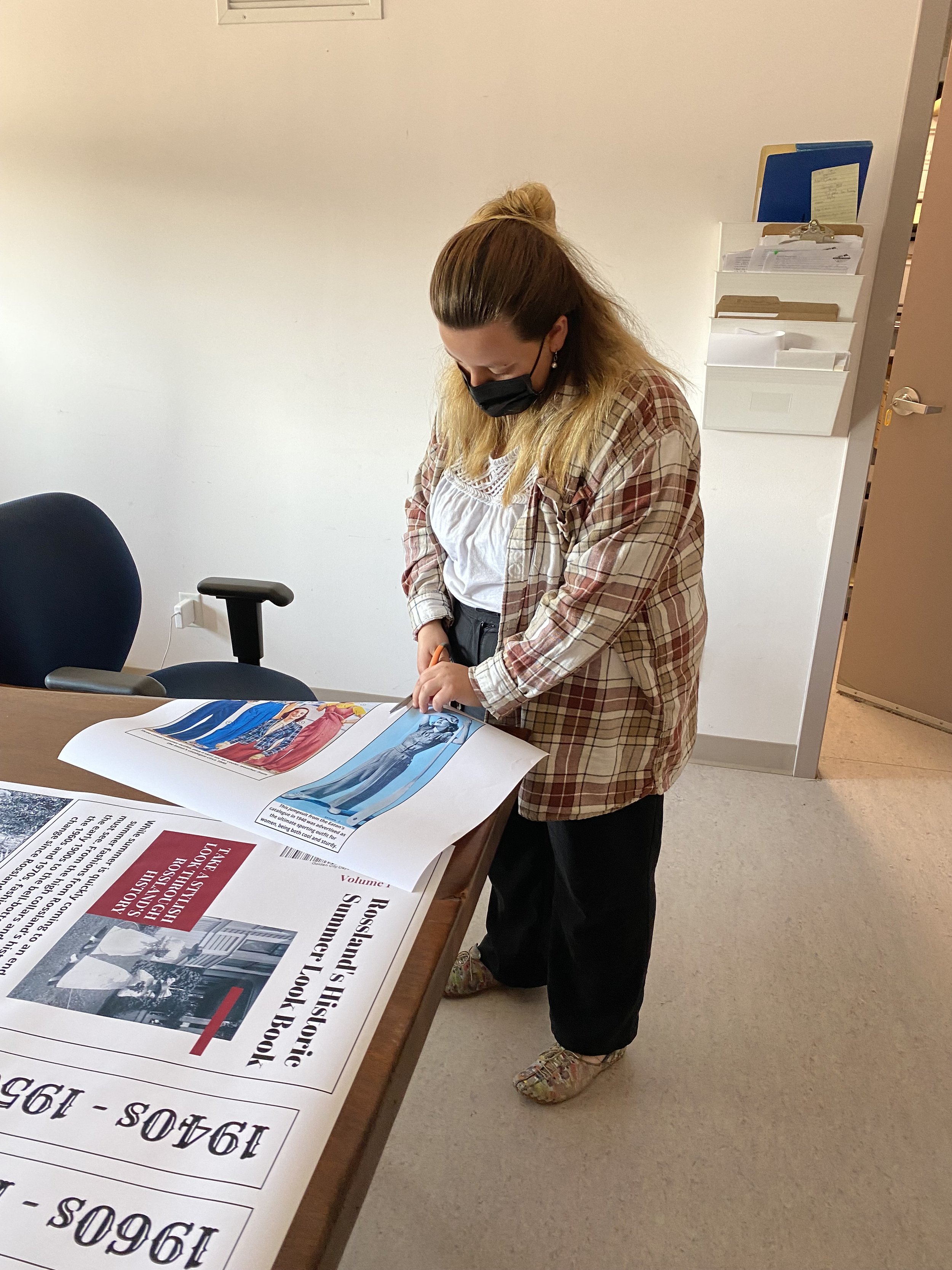 Archives/Collections Assistant Kestra prepping panels