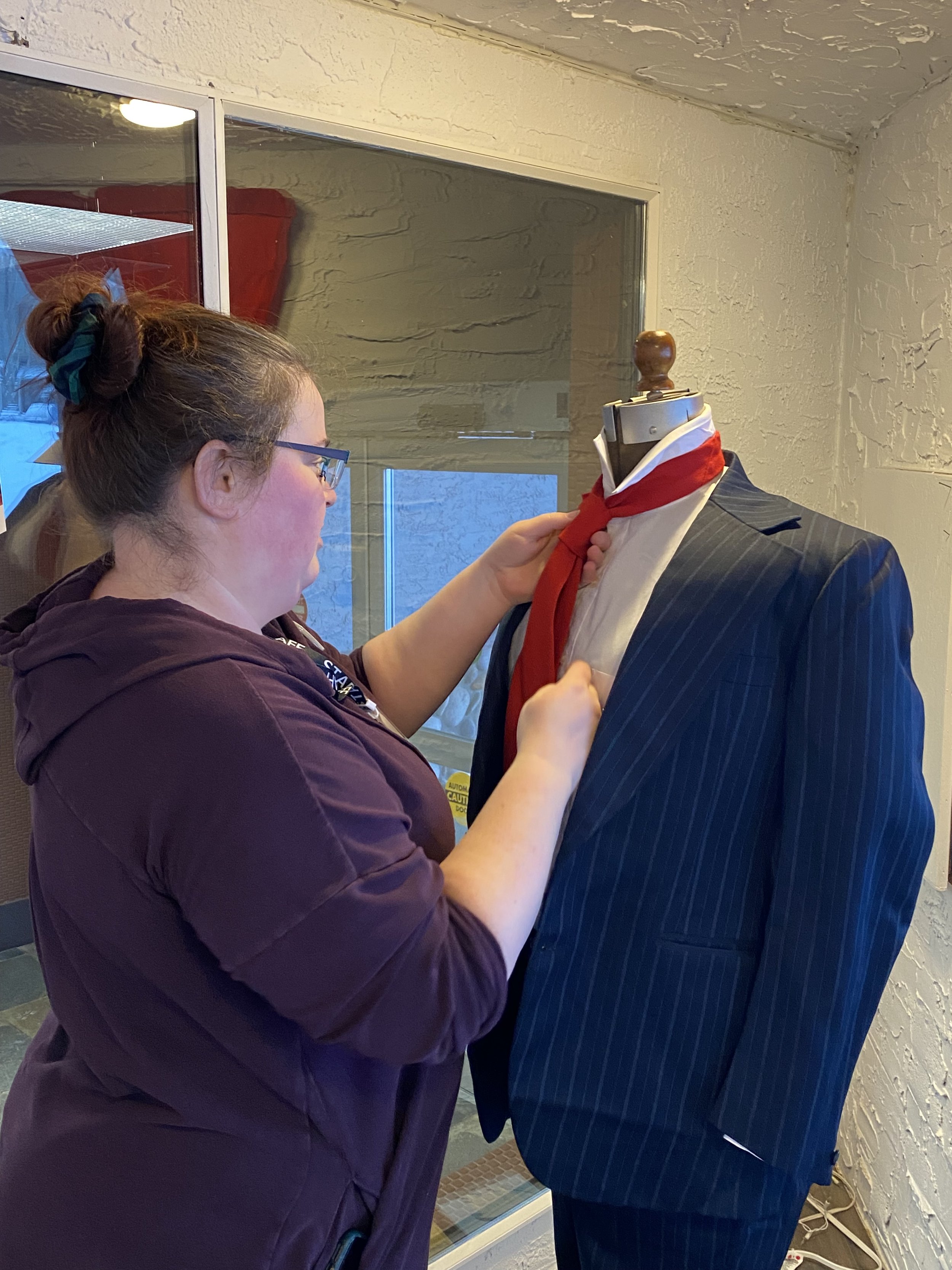 Collections Manager Sara Installing Textiles for Guys and Dolls Highlight