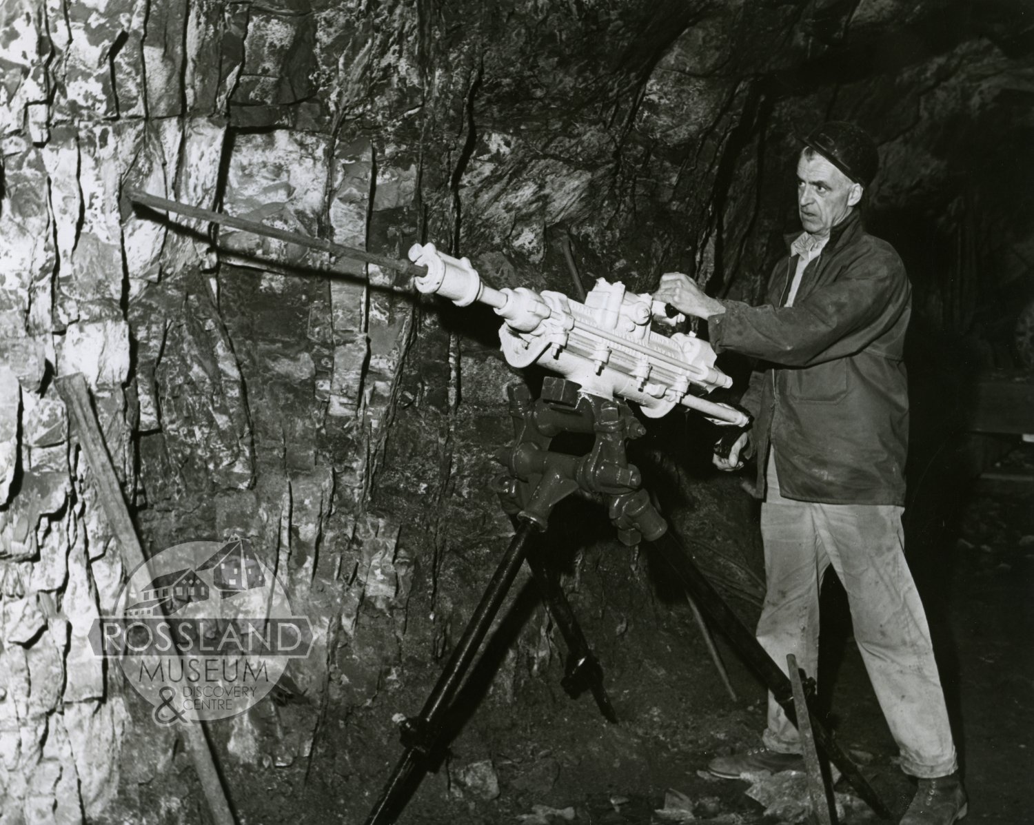 Photo 2276.0125: Roger Terhune using a 1930 vintage Little Giant drill at the Rossland Museum underground tunnel, 1968