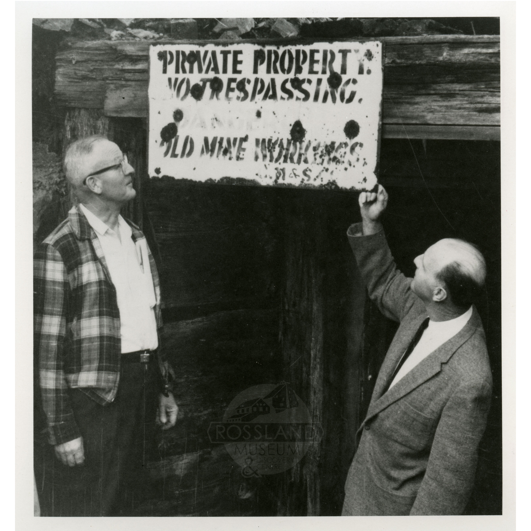 Photo 2276.0117: Harry Lefevre and Jack McDonald examine the portal of the Black Bear Mine, July 1965