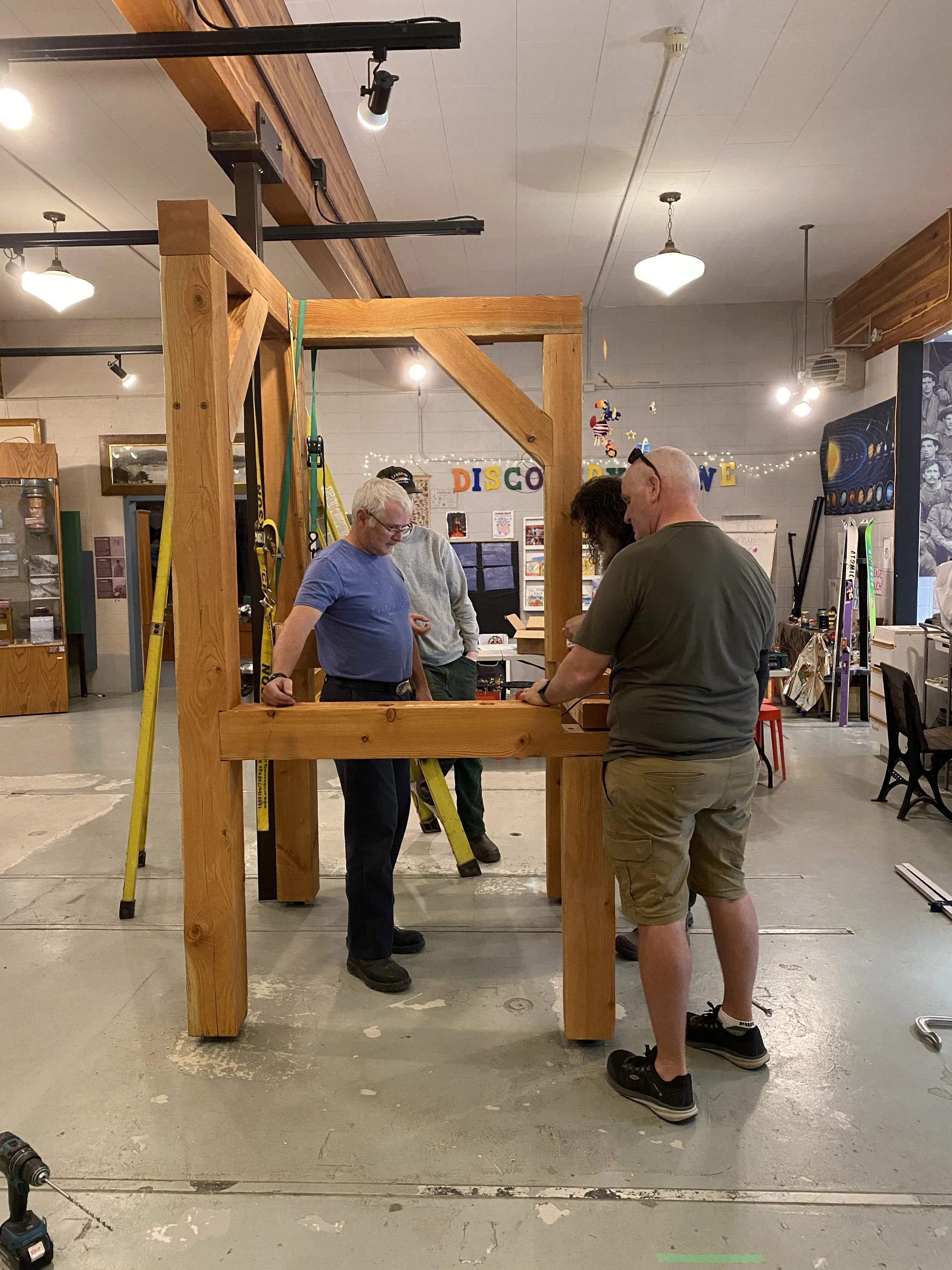 Members of the Selkirk Technology Access Centre building the frame