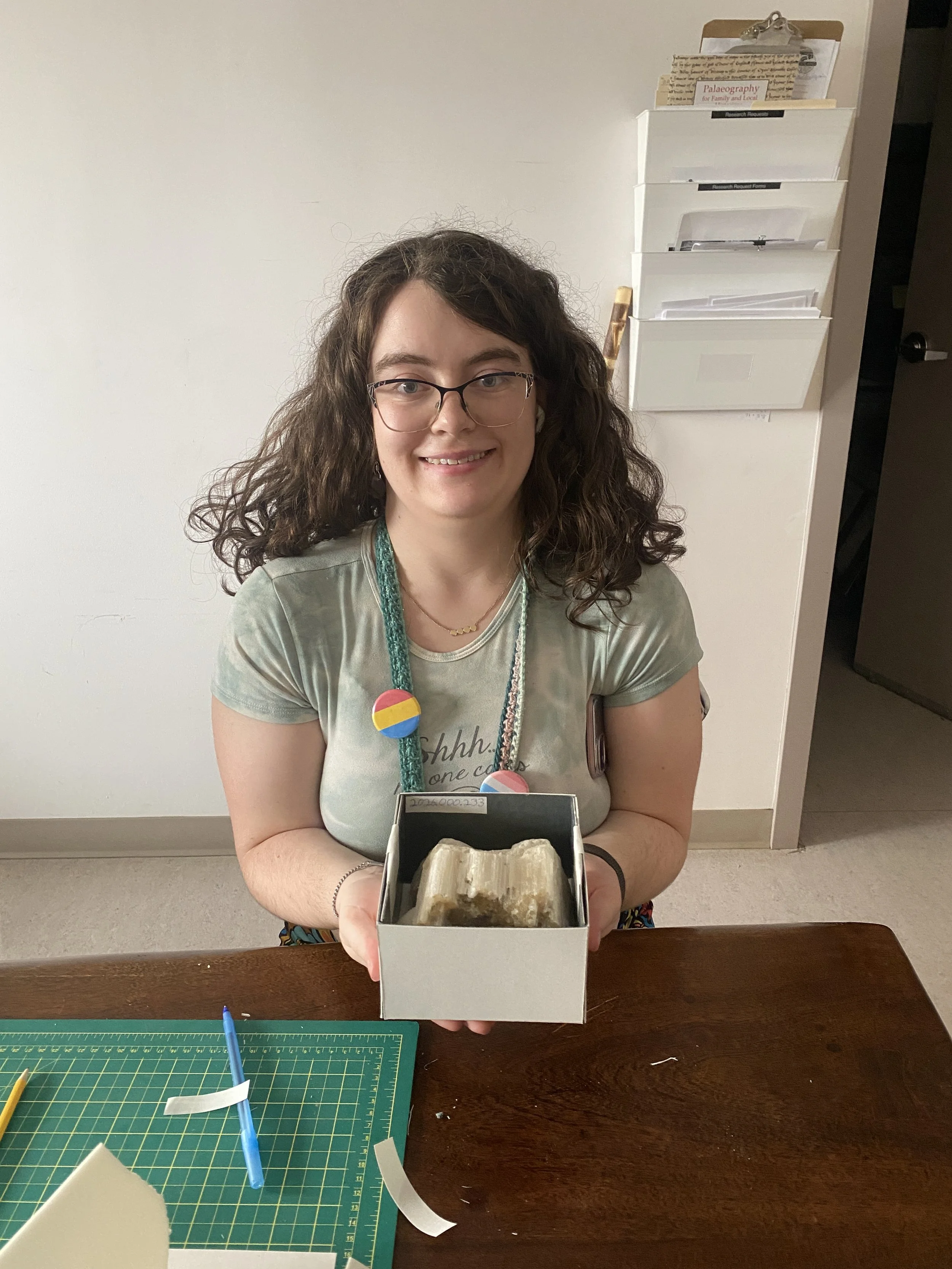 Brenna with the custom box she made for a delicate mineral specimen in the collection