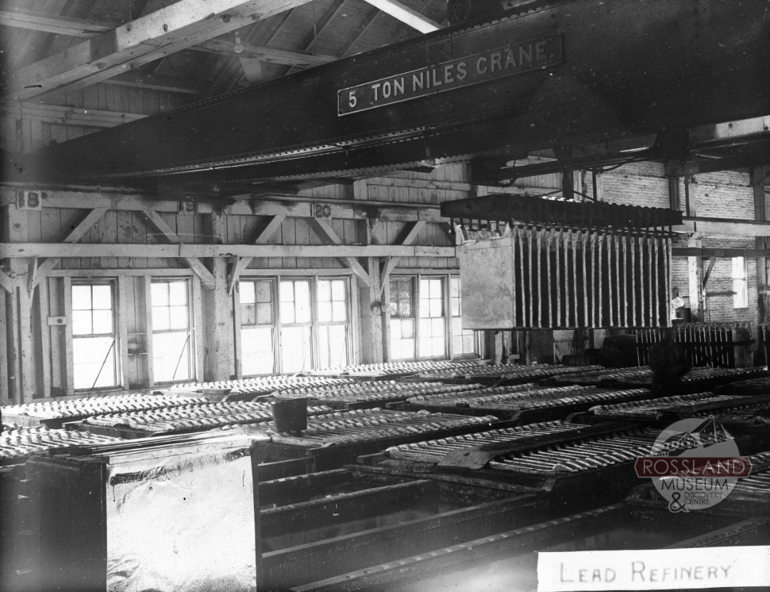 Black and white photograph of the inside of a industrial smelting building
