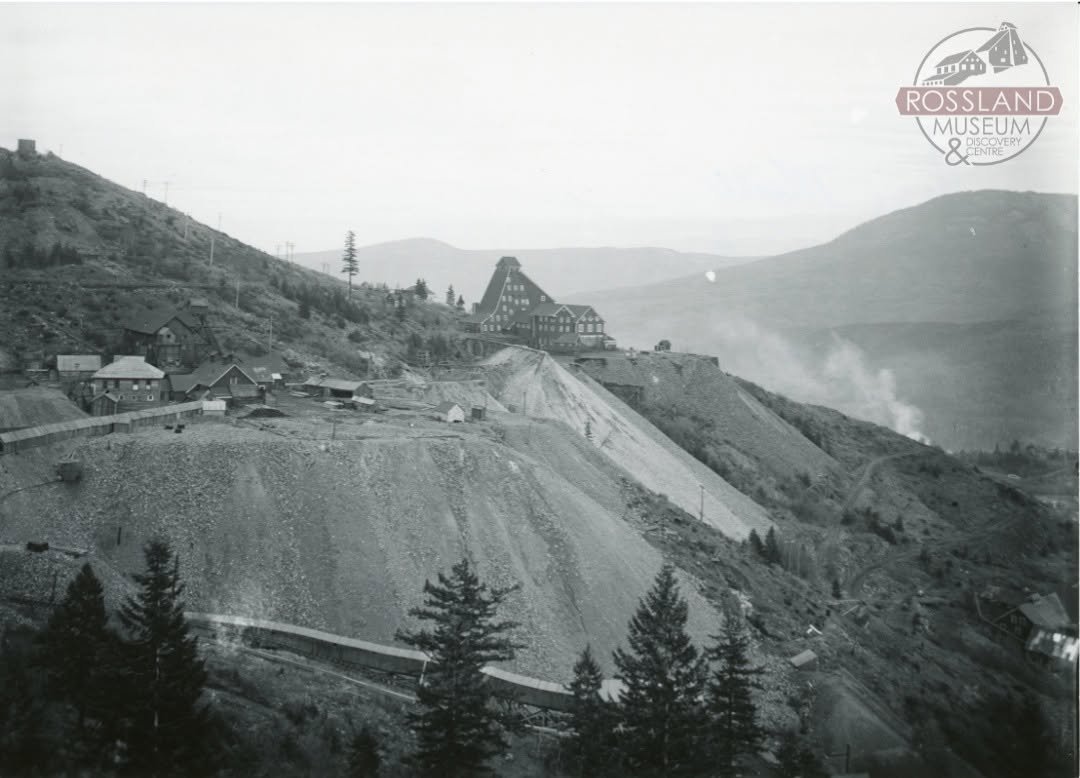 Black and white photograph with three mines on a mountain