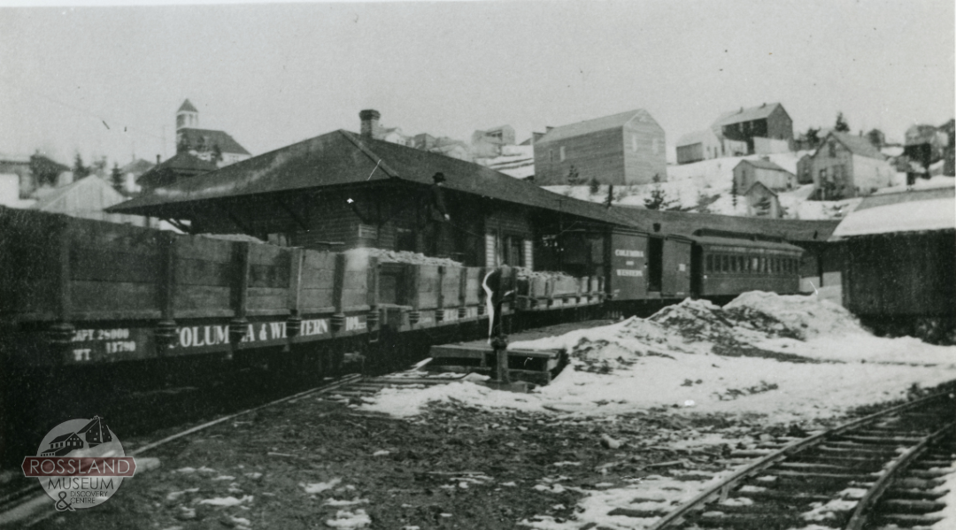Black and white photograph of a ore train at a train station