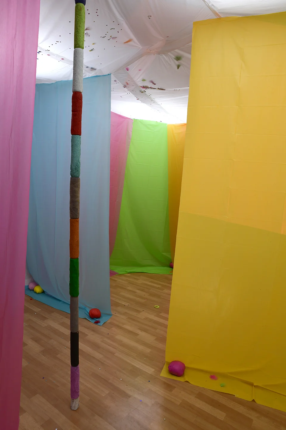 Hueston , video projection, plastic table cloths, used paint rollers, paper, tape, string, and wood, dims vary, 2019