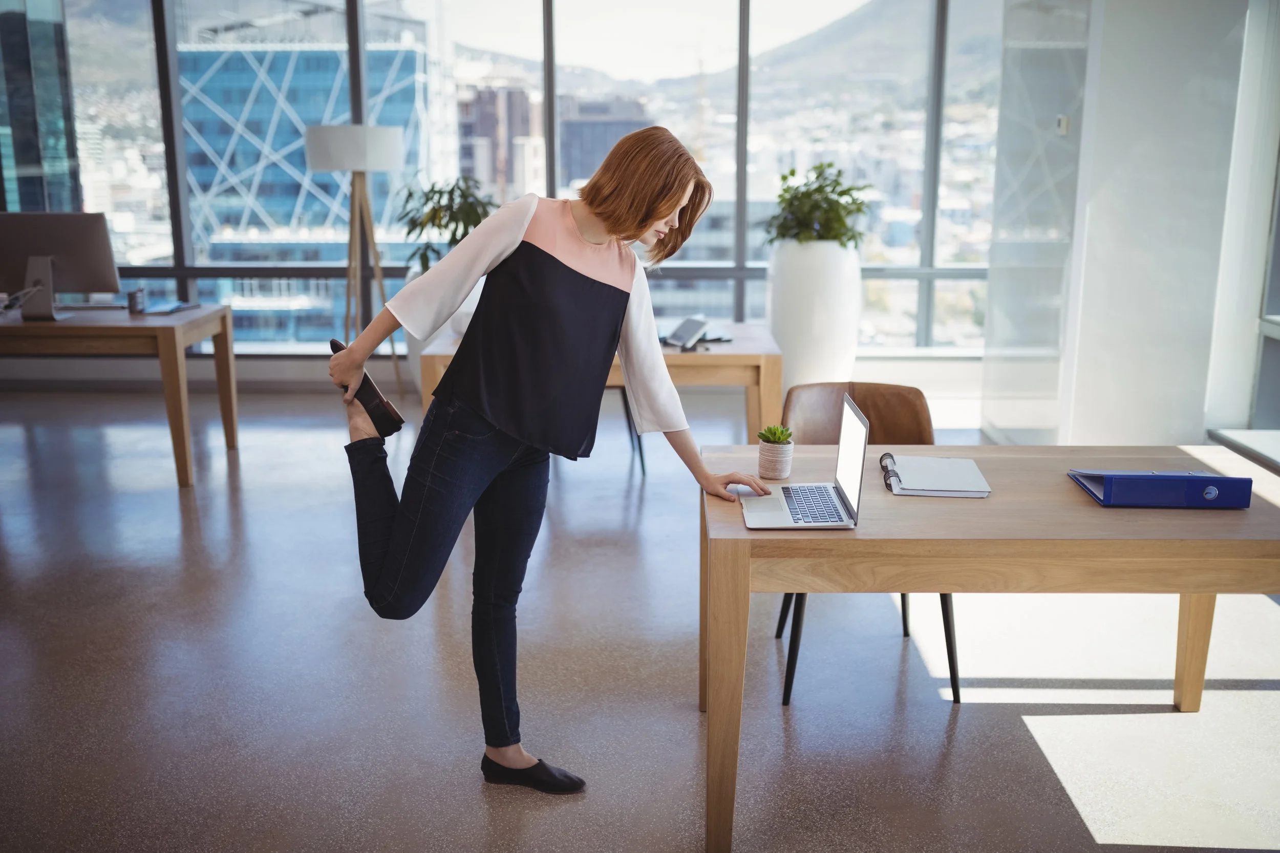 BWFS Image Woman stretching by desk.jpg