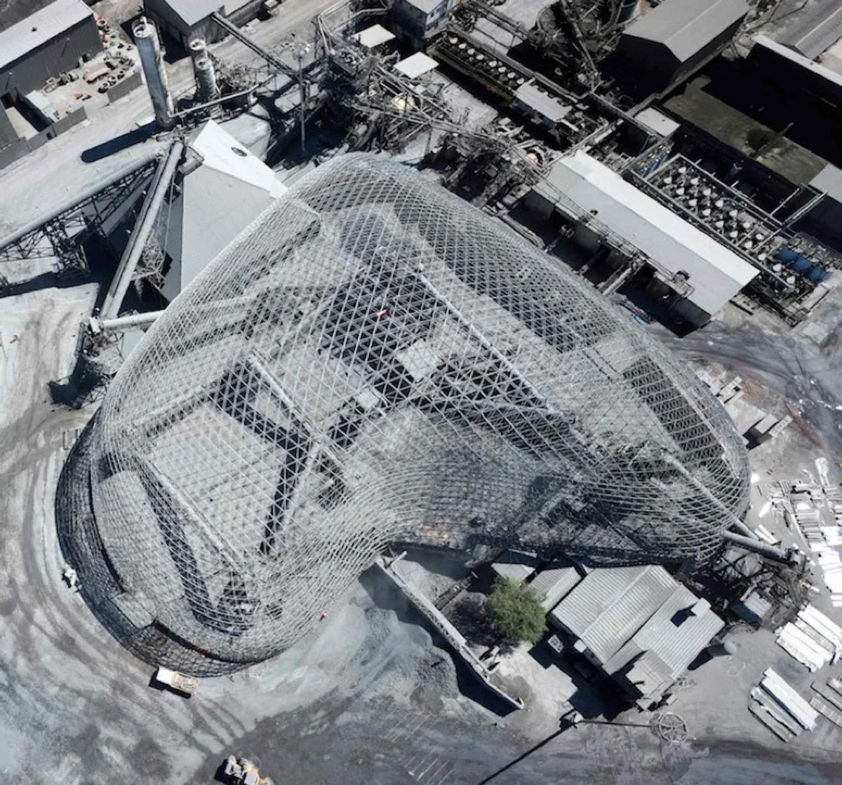 The irregular shape of the copper ore processing dome spans 90m over a stockpile, equipment and buildings