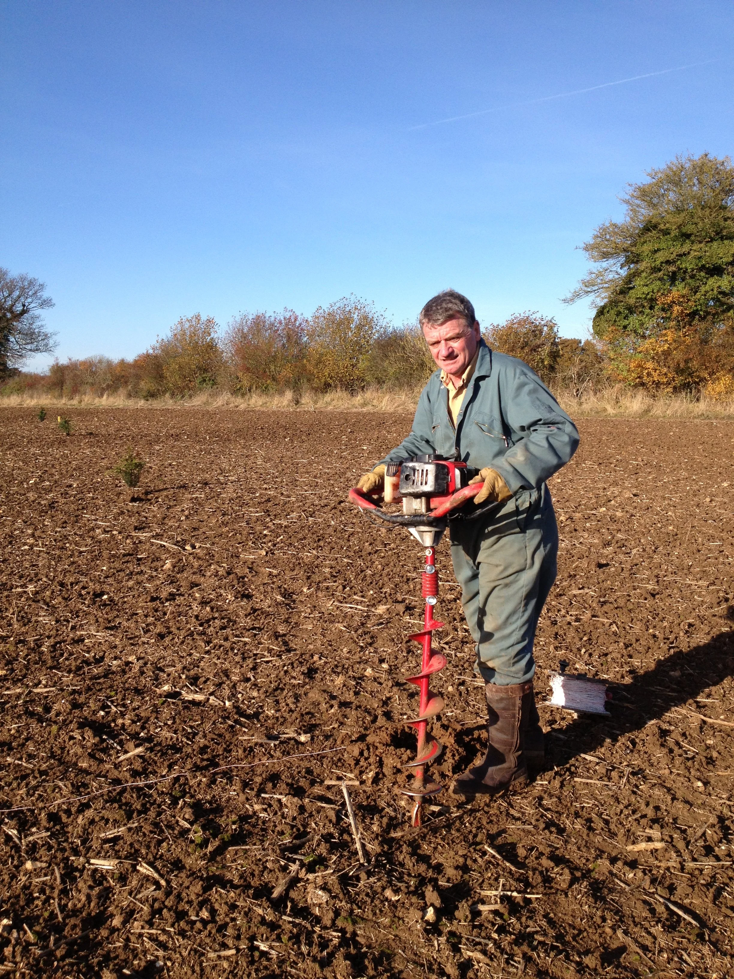W2 Kieron makes the first planting hole.JPG