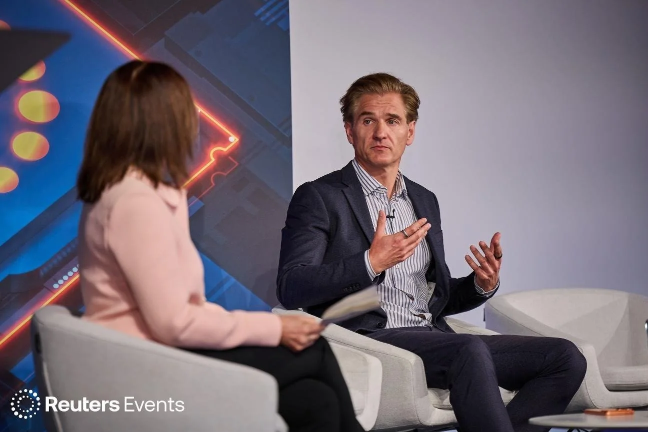 Christian Guttmann seated on stage in conversation with Vanessa O’Connell at Reuters Momentum AI in London