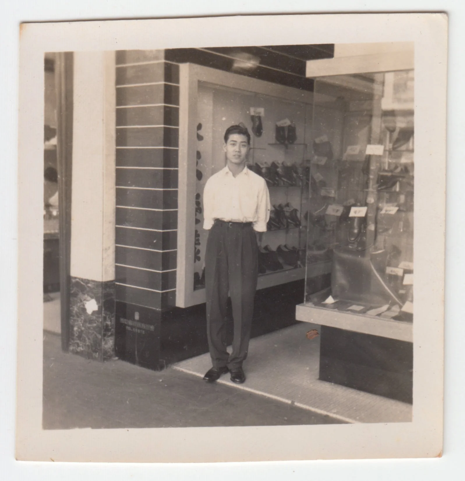 Grandpa at the shoe shop, c. 1940s - 1950s.