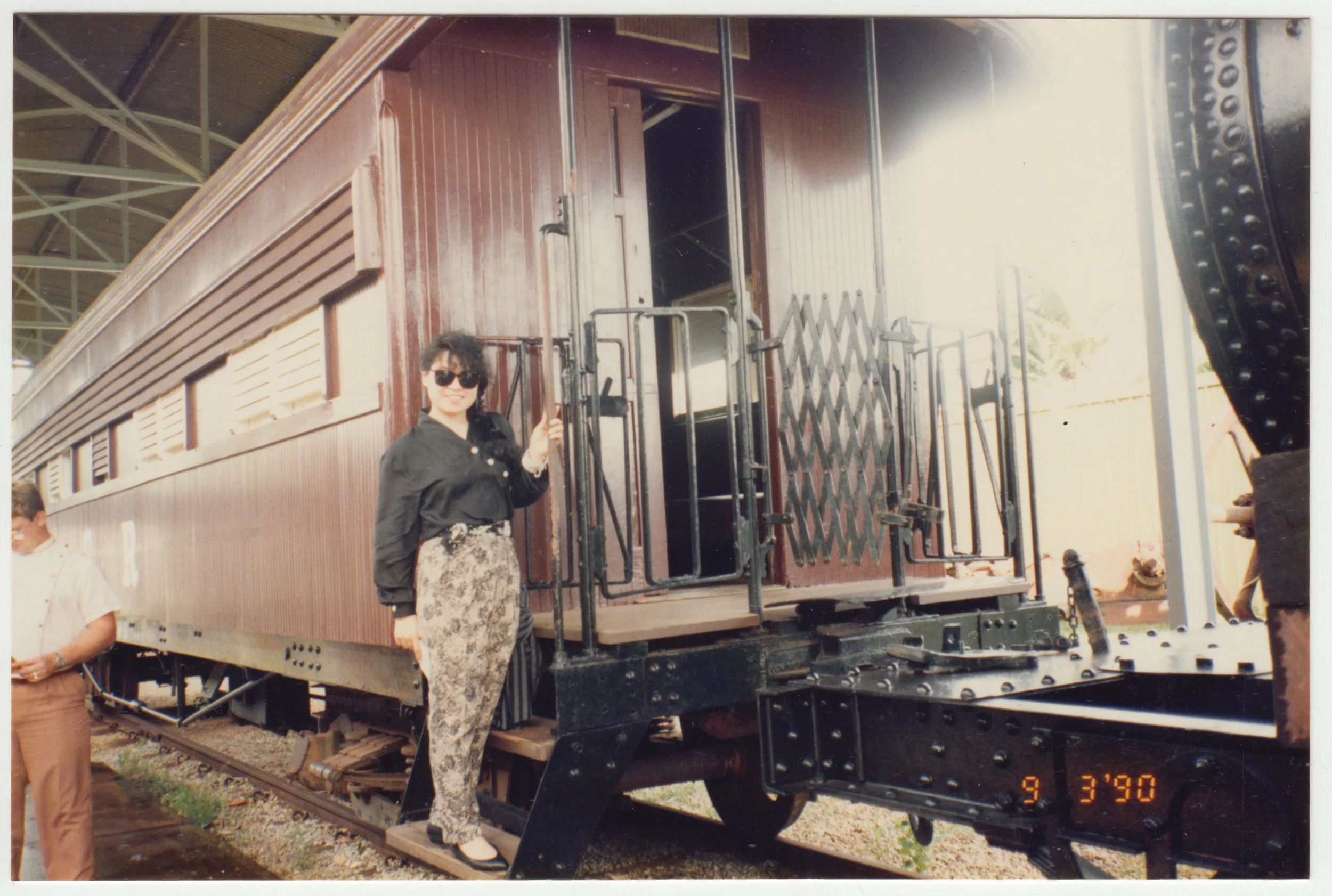 Mum posing next to a train carriage in Australia, taken on 9 March 1990