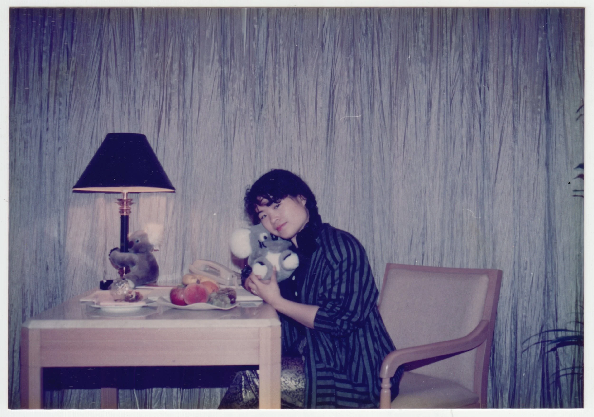 Mum cuddling a Koala toy in the hotel room in Australia, c. March 1990