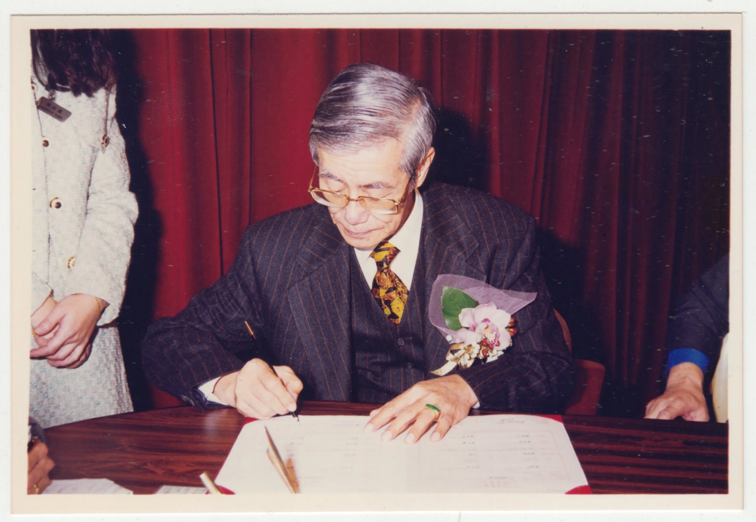 Grandpa signing EE’s wedding certificate, c. December 1997.