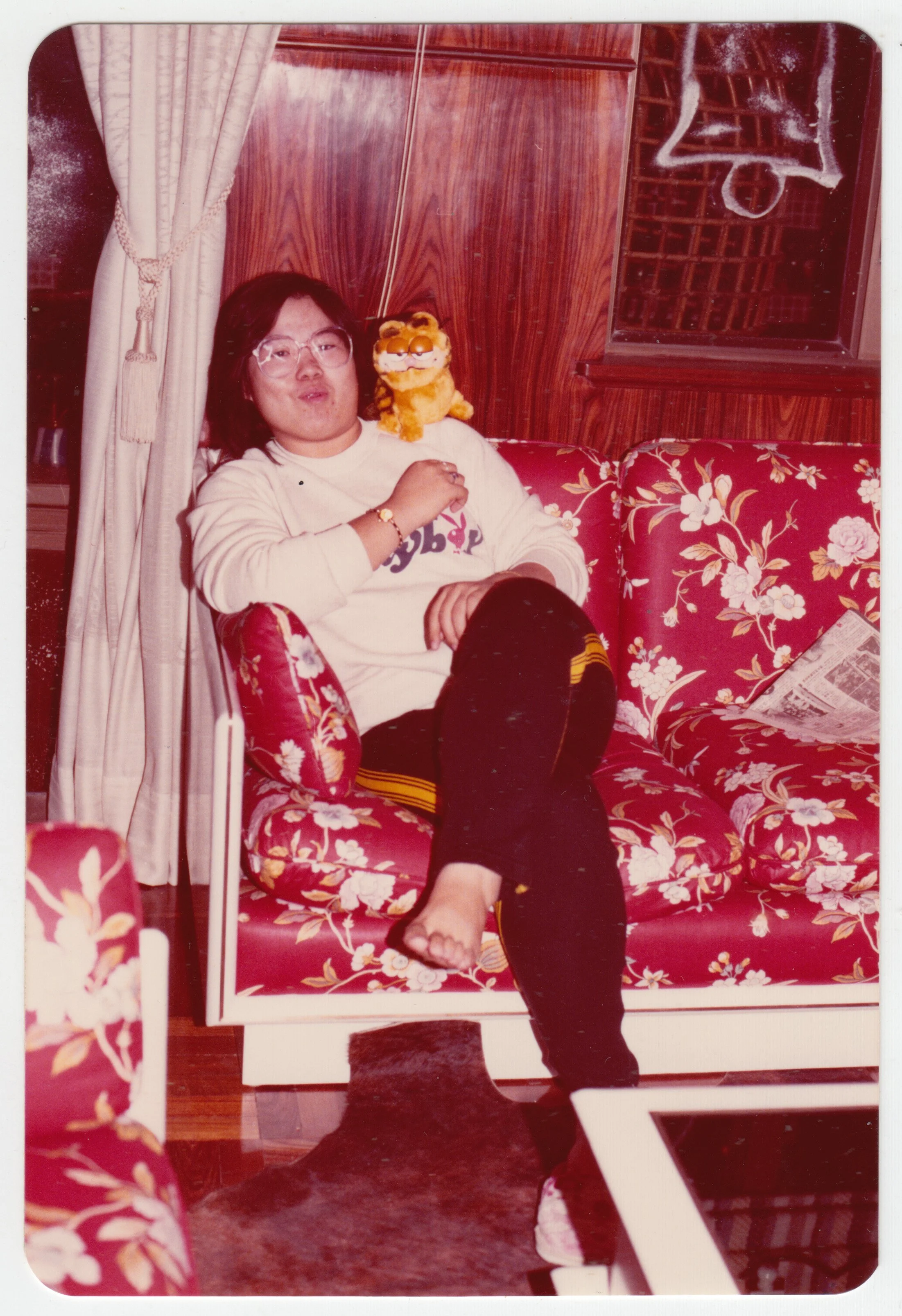 Mum in the living room with a Garfield plush, at home on 18/F, c. 1980-1981.