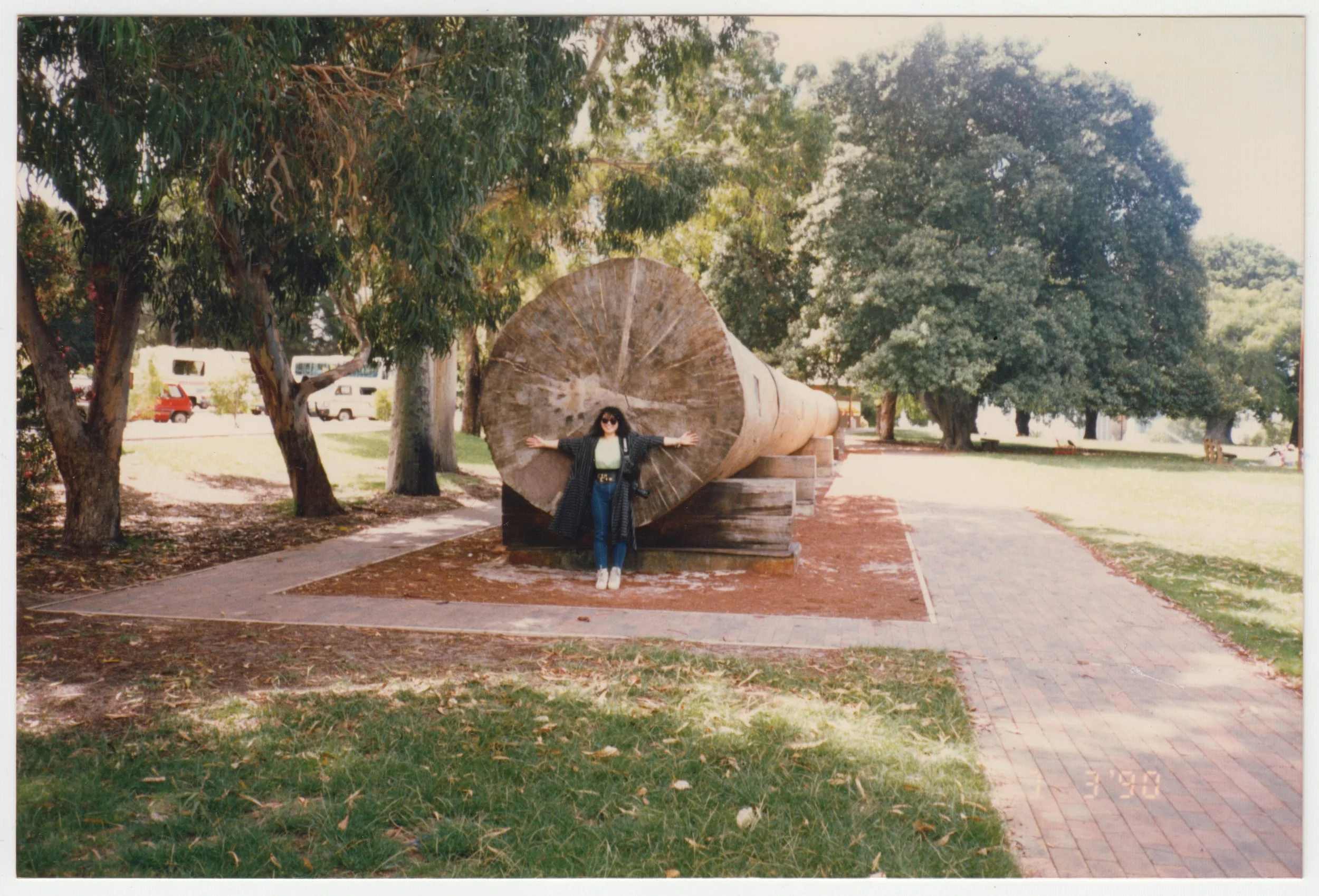 Mum posing next to a giant felled tree in Australia, taken on 7 March 1990. 
