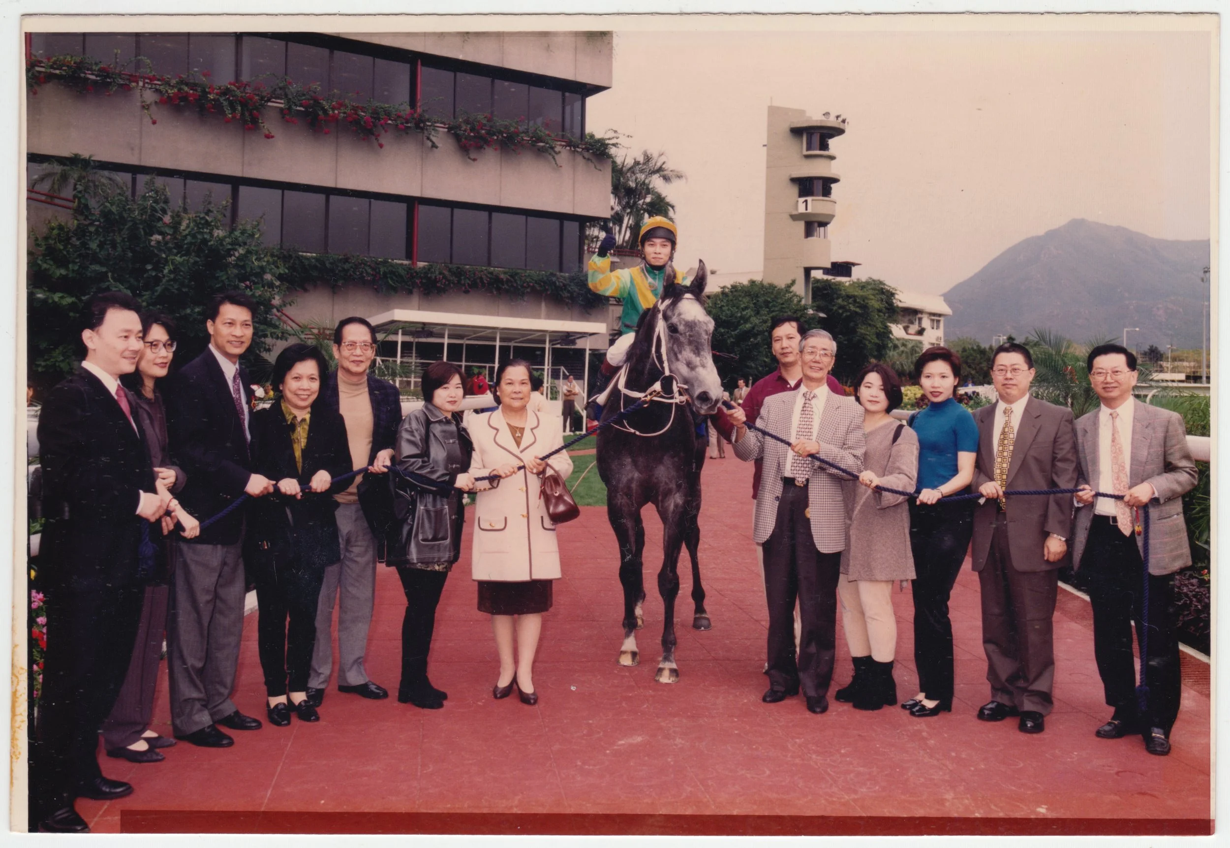 no. 00338 / Racehorse Victory 拉頭馬, c. 1998. 
From left to right:
EE’s Ex-husband, four people who are ‘friends’ with Grandpa, EE, Grandma, Jacky C K Tse on Cosmos One, Horse Handler, Grandpa, Mum, 舅母, Uncle Edward, Dr. Andy Kong.
