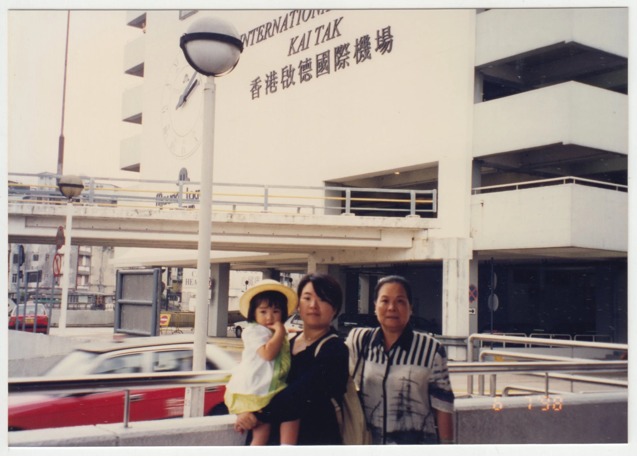 Grandma, Mum & Charlotte at Kai Tak Airport, Hong Kong, taken on 6 July 1998.