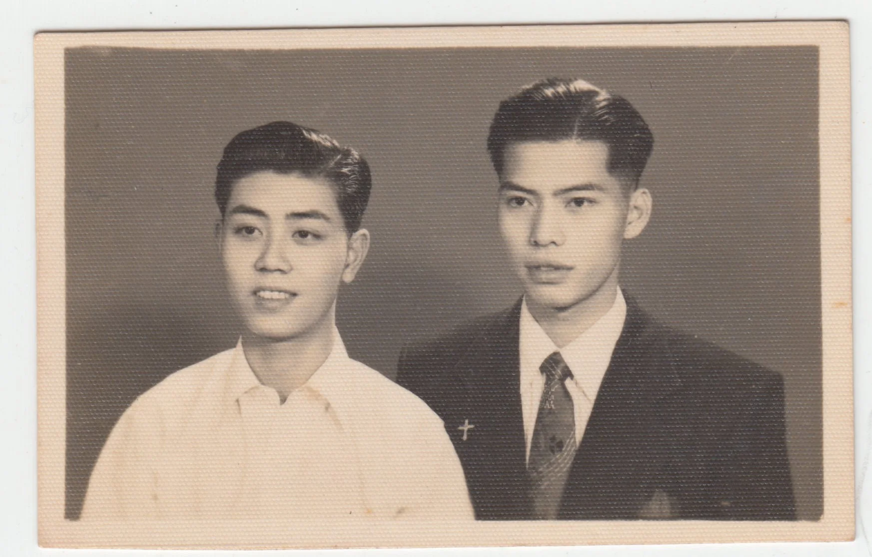 A photograph of Grandpa with a cousin or a friend, 1 January 1954. (RECTO)

On the reverse, Grandpa writes the name of the photography studio in Sham Shui Po, as well as the date and the fact that it was New Year’s.