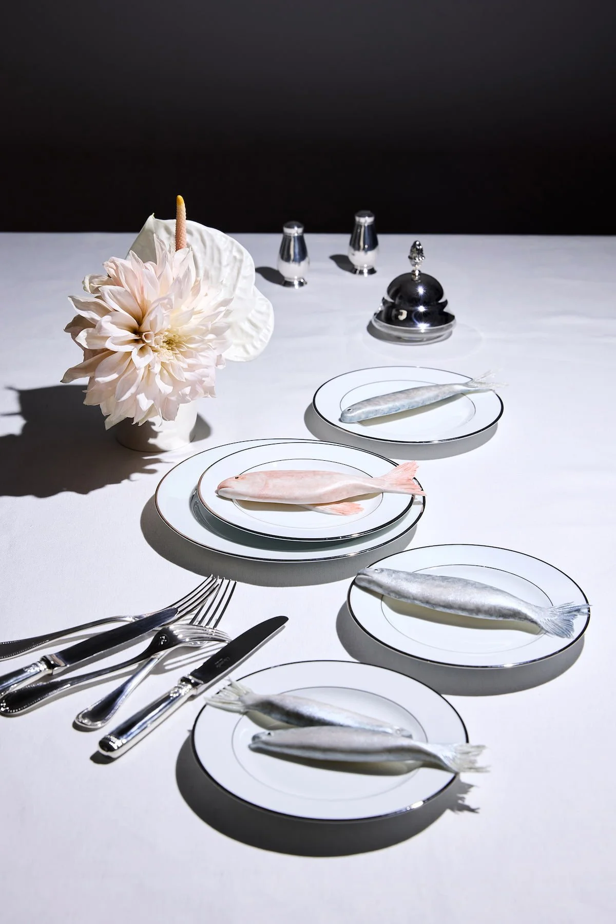  Trompe-l'œil table setting with sugar sculpture fish arranged across a series of plates, creative direction by Chi-Young Bang 