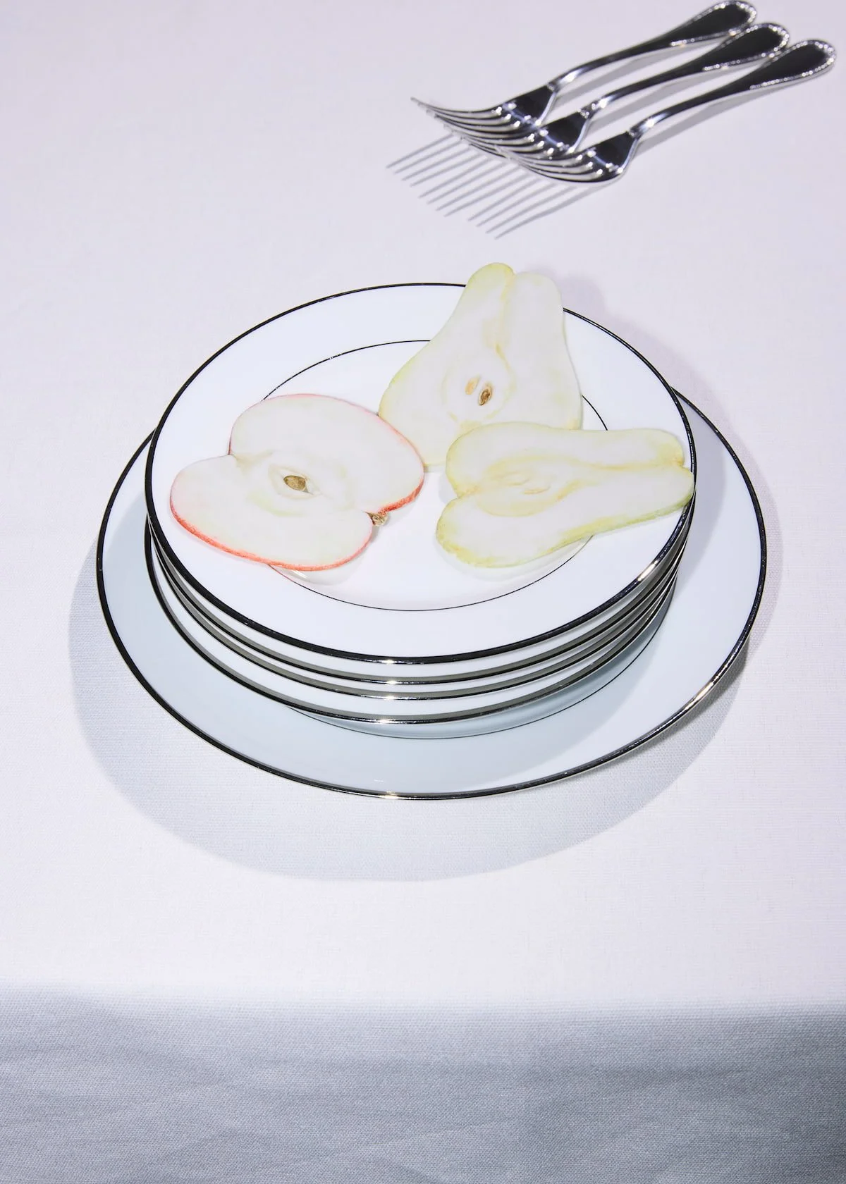  Sugar sculpture fruit, sliced apple and pear rendered entirely in sugar, styled on stacked tableware. Creative Direction and concept by Chi-Young Bang 