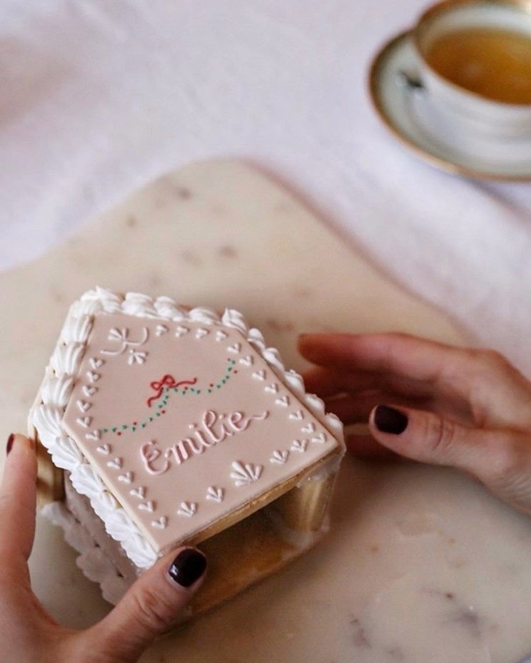  Personalised gingerbread house with hand-piped name detail, presented at an intimate press event 