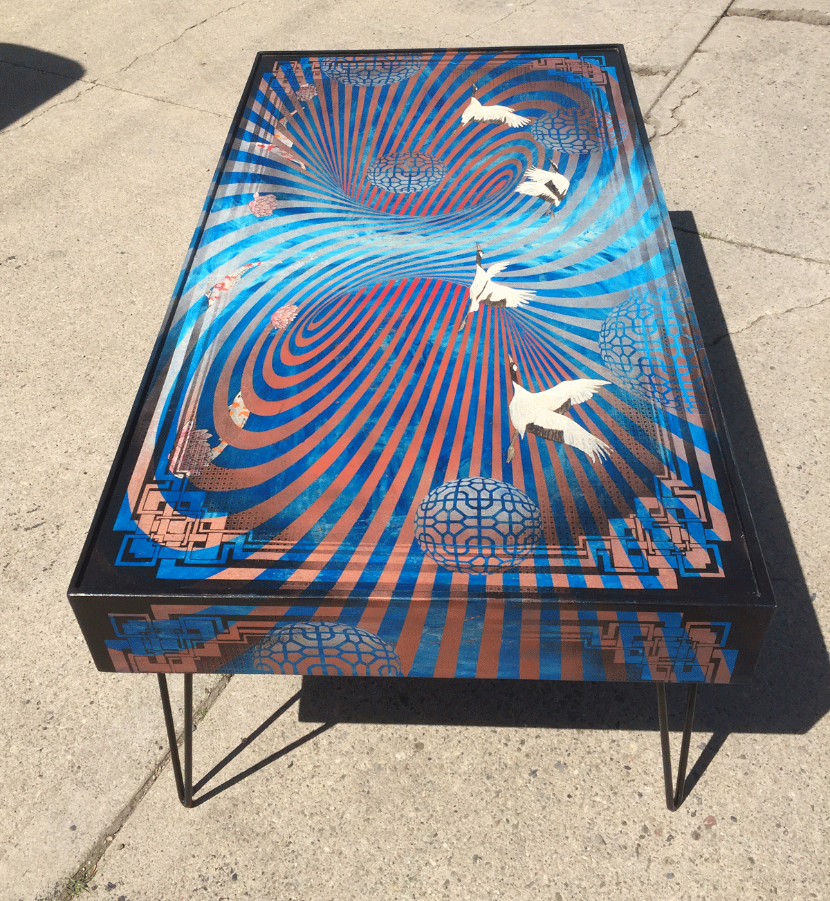  katy’s monster  commissioned coffee table measuring 49"x27"x18" tall  mixed media on maple panels with steel hairpin legs. 