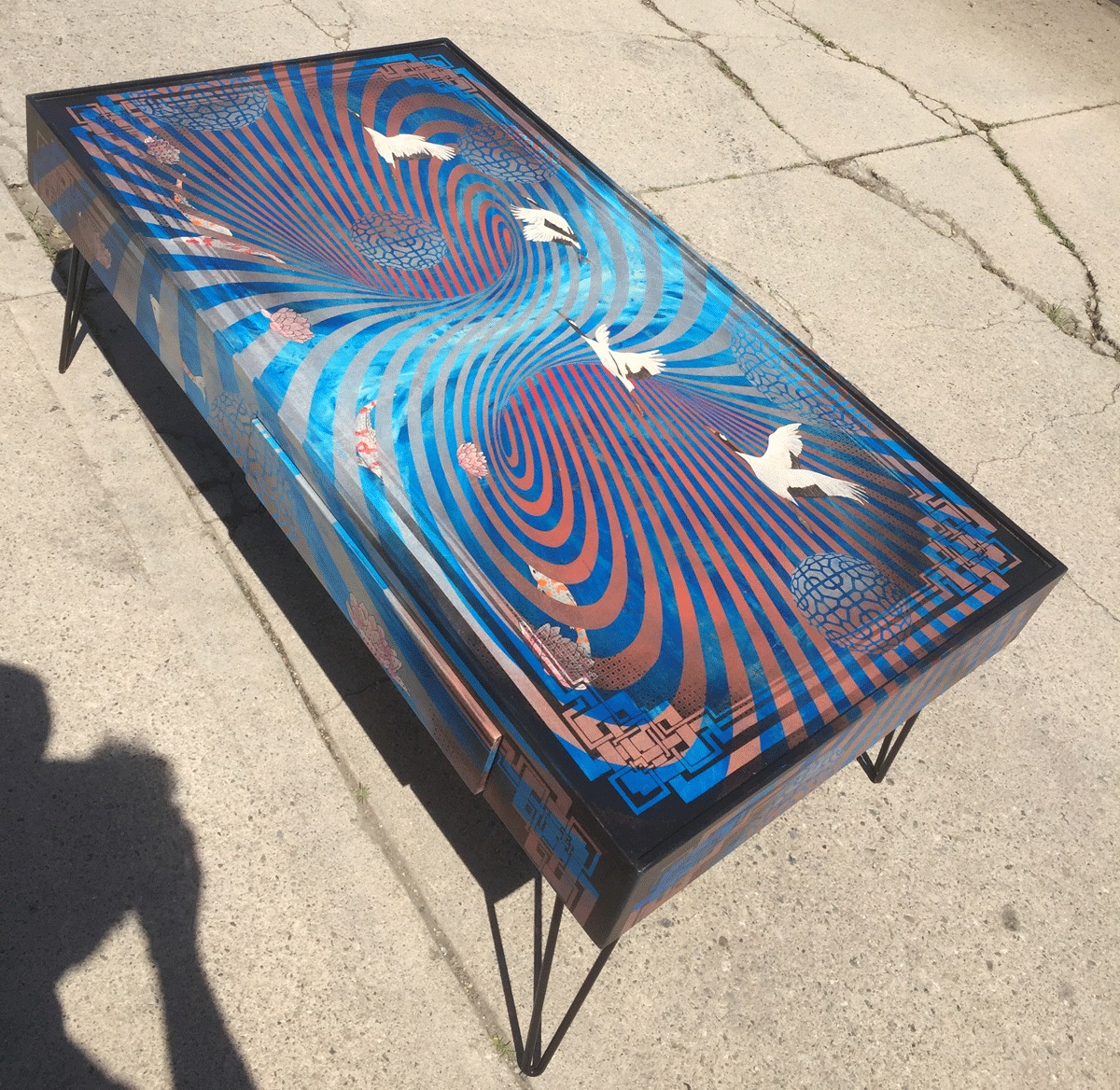  katy’s monster  commissioned coffee table measuring 49"x27"x18" tall  mixed media on maple panels with steel hairpin legs. 