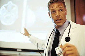 doctor teaching in front of screen