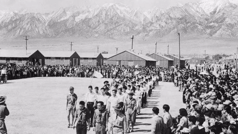 A public ceremony at the bleak Manzanar internment camp in Owens Valley, California. From the LA Times.