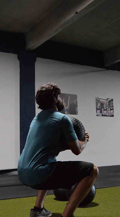 Guy lifting heavy medball