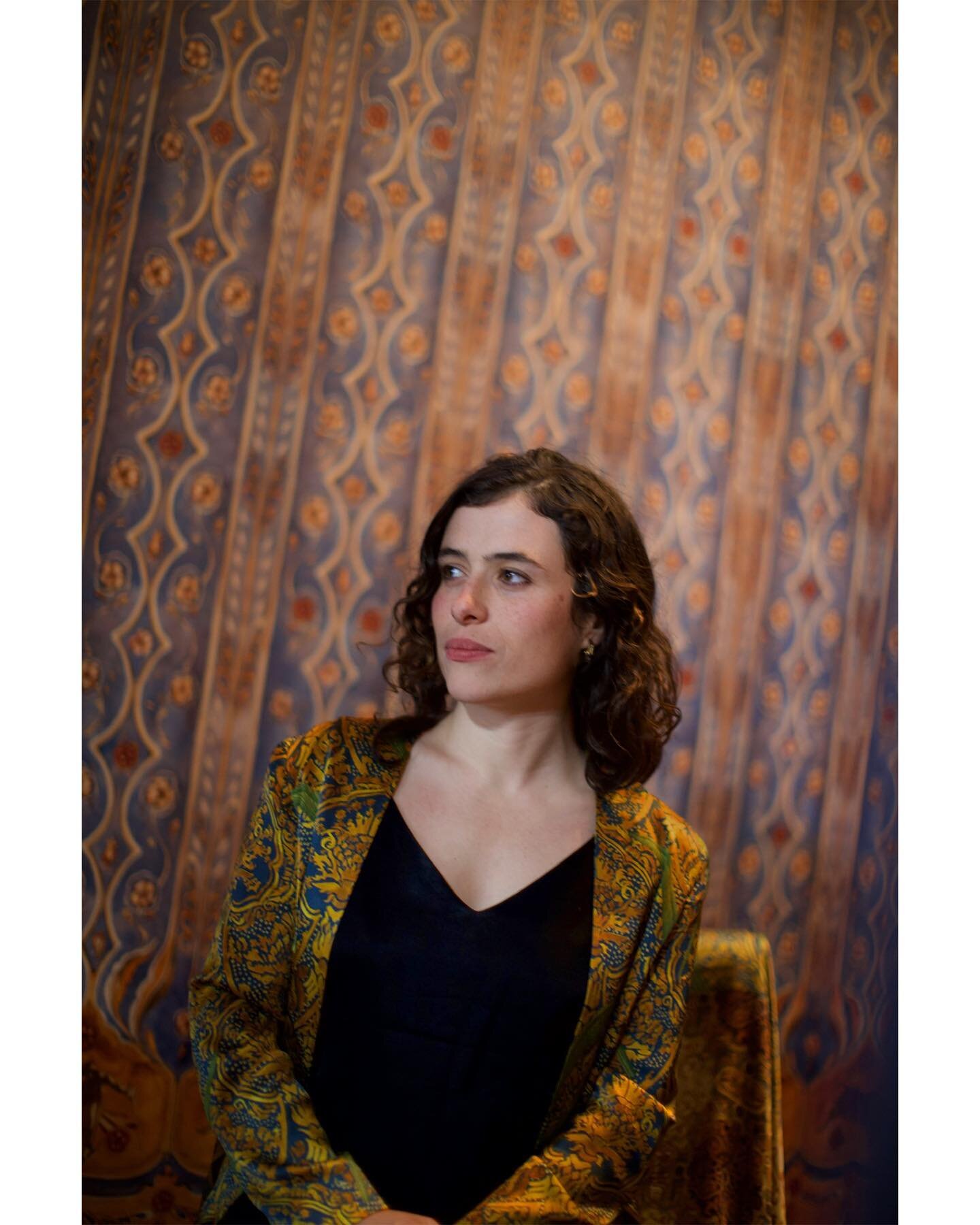 Ethereal &amp; enigmatic Mariana, a wellspring of quiet beauty and grace.  Artist, designer and collaborator-in-chief of Tulicarpa, wearing her St. Catherine silk coat in front of our Toreador wallpaper.  We have created 25 patterns together over the