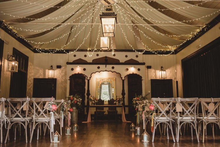Indoor Unique Ceremony Venue Wiltshire with Crossback Wedding Chairs and light draping