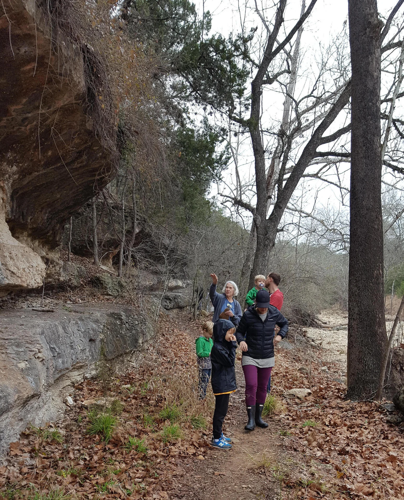 Exploring the limestone cliffs adjacent to the dry Cypress Creek during hike at JWNA.