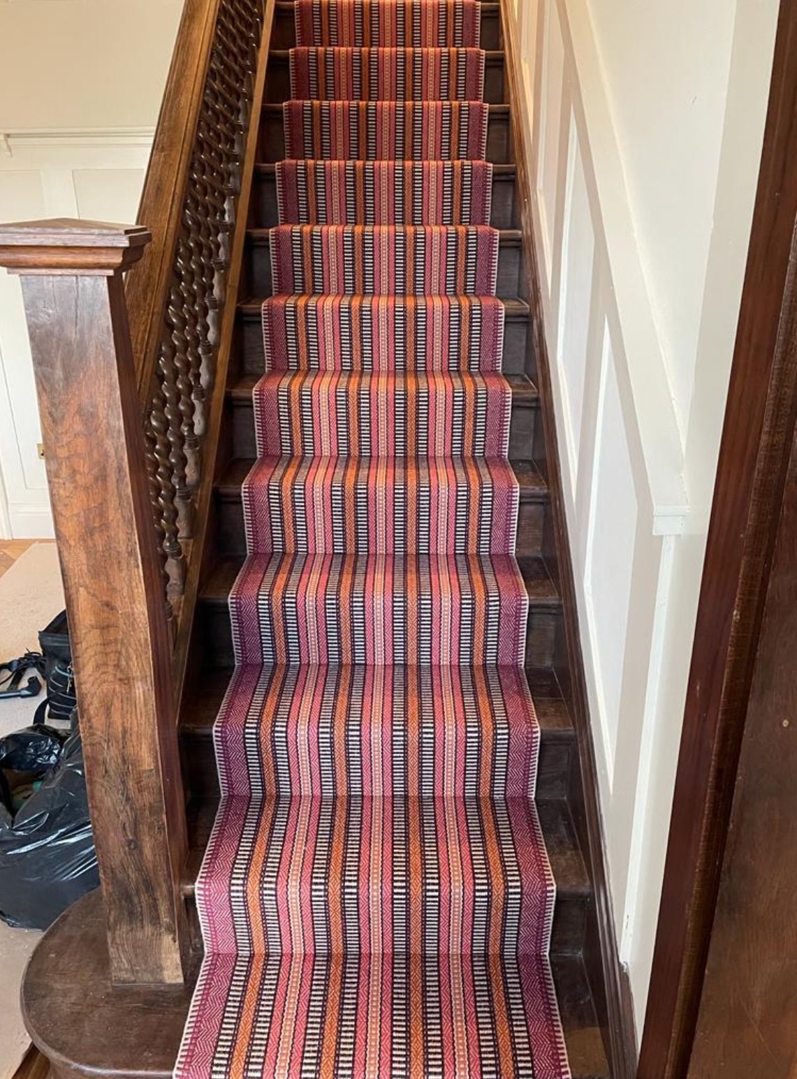 The striped runner on the main stairs