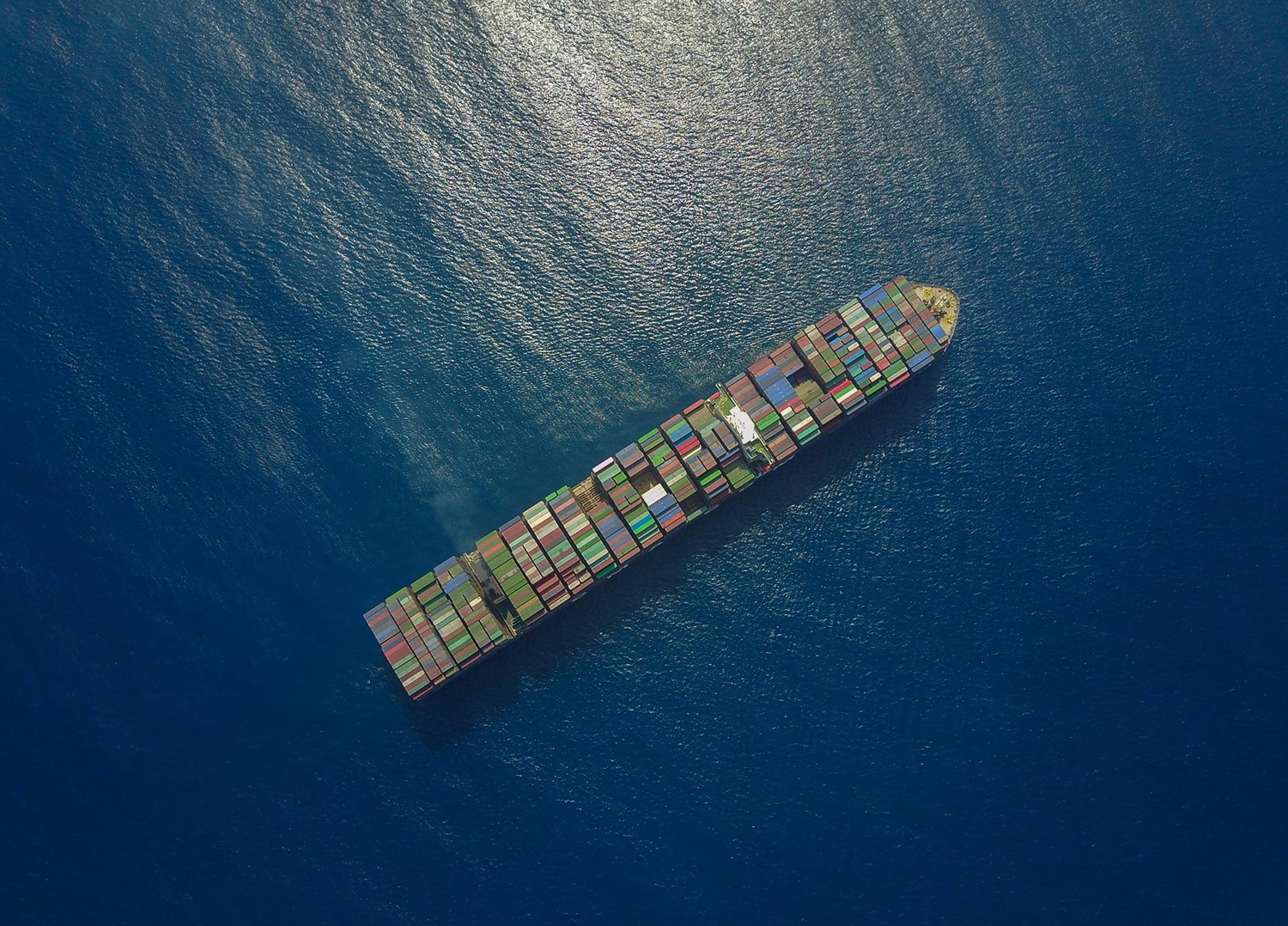 aerial-view-ocean-shipping-container-alexander-unsplash.png