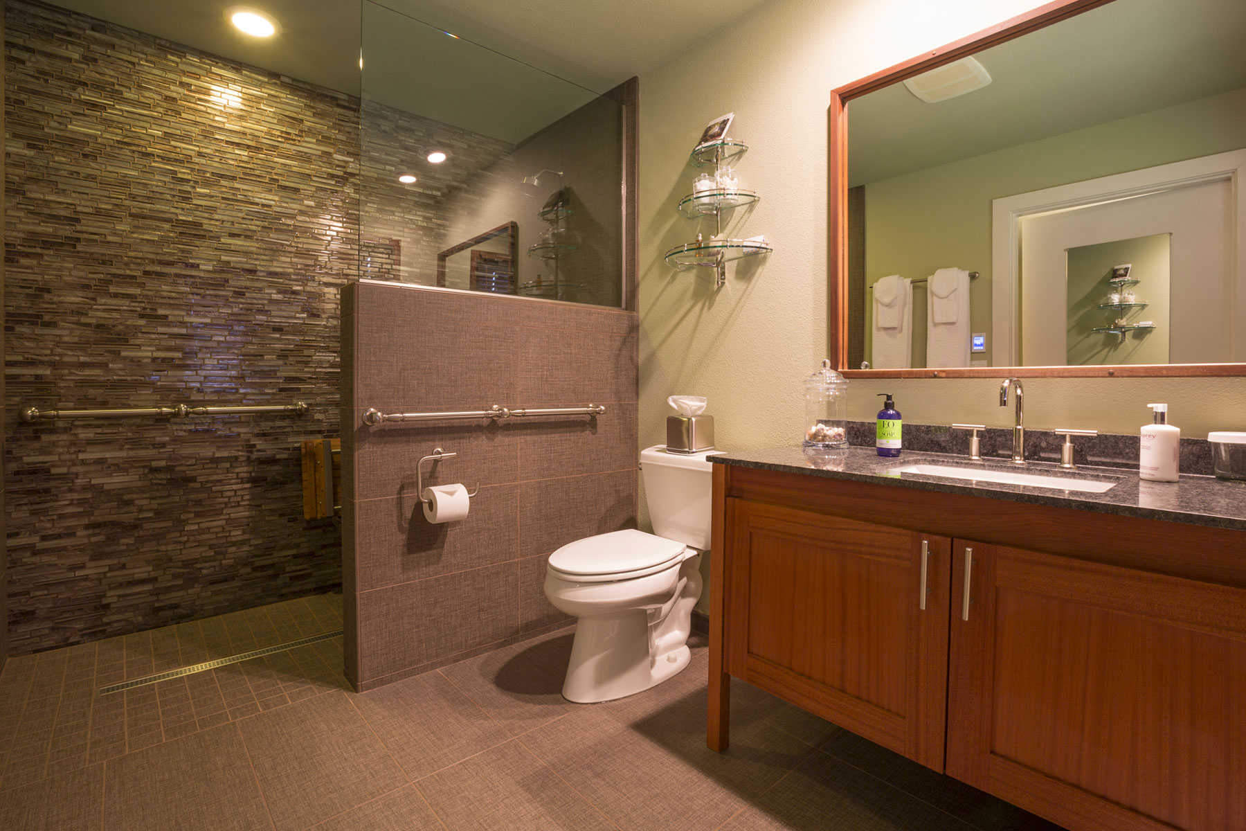 The Redwood room bathroom with support bars by toilet and in the roll-in shower