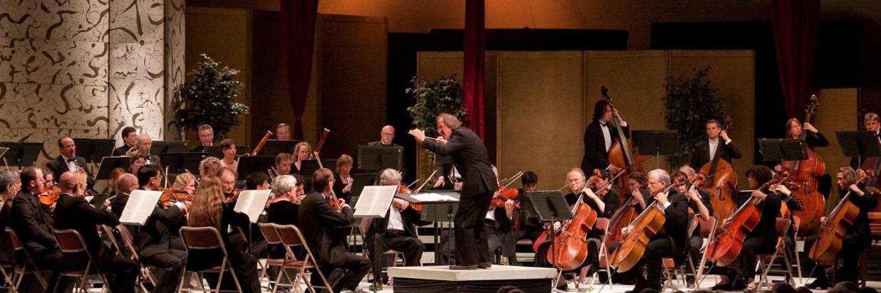 The conductor guides the orchestra through the music at the Mendocino Music Festival