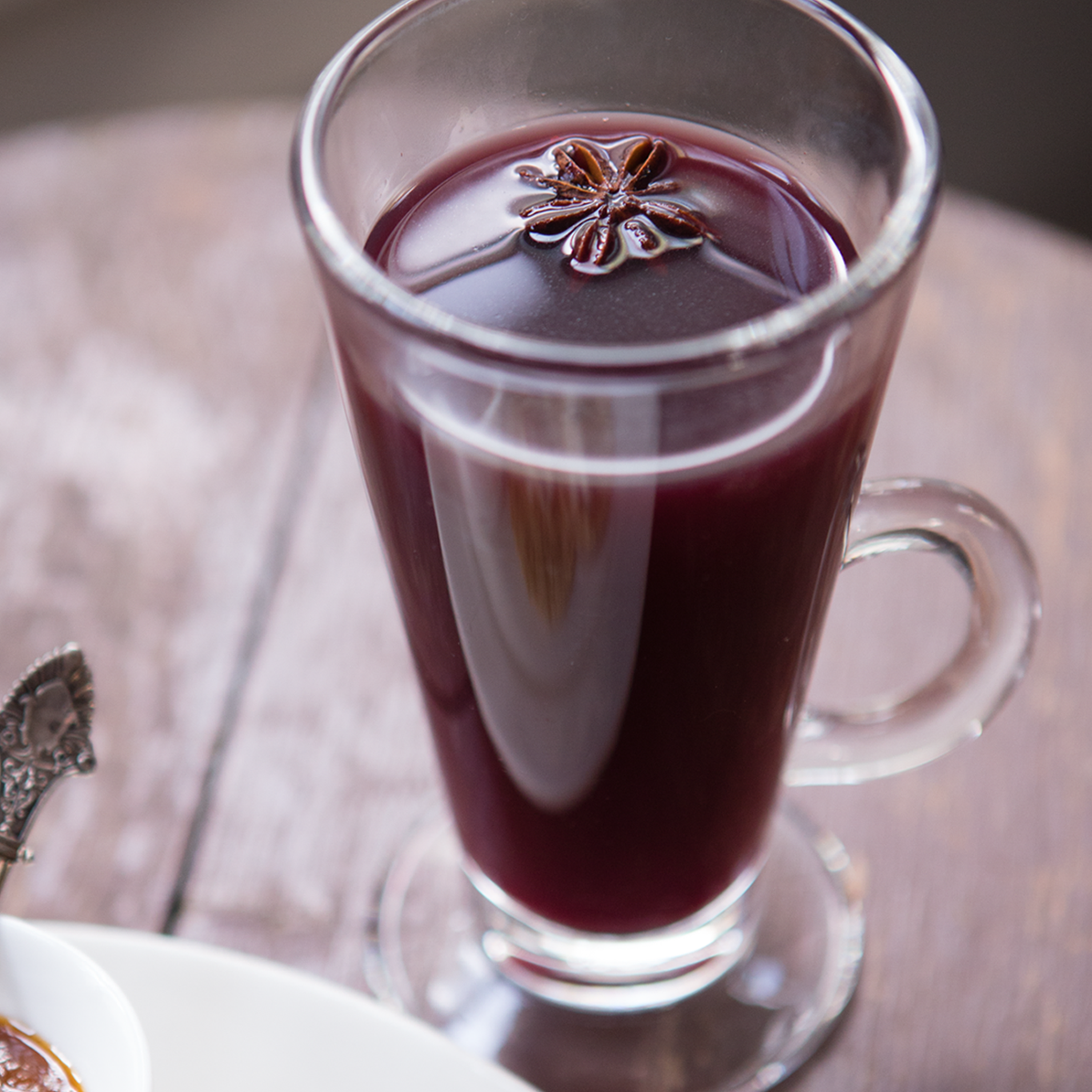 photo of a glass of mulled wine with anise star