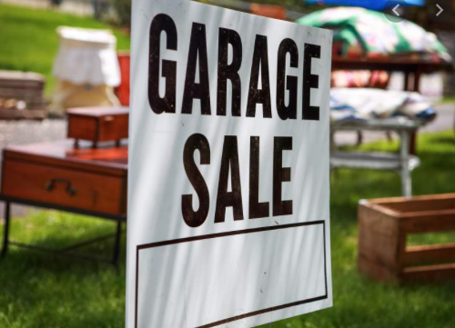 photo of a garage sale sign in front of a yard sale