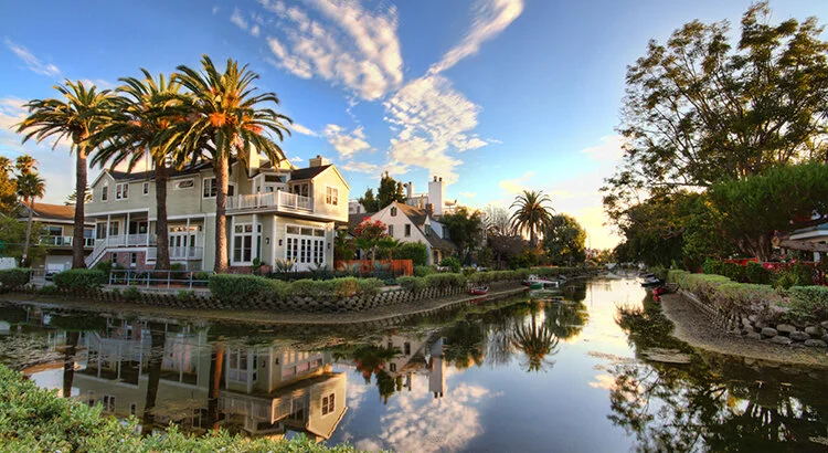 home on a canal with palm trees