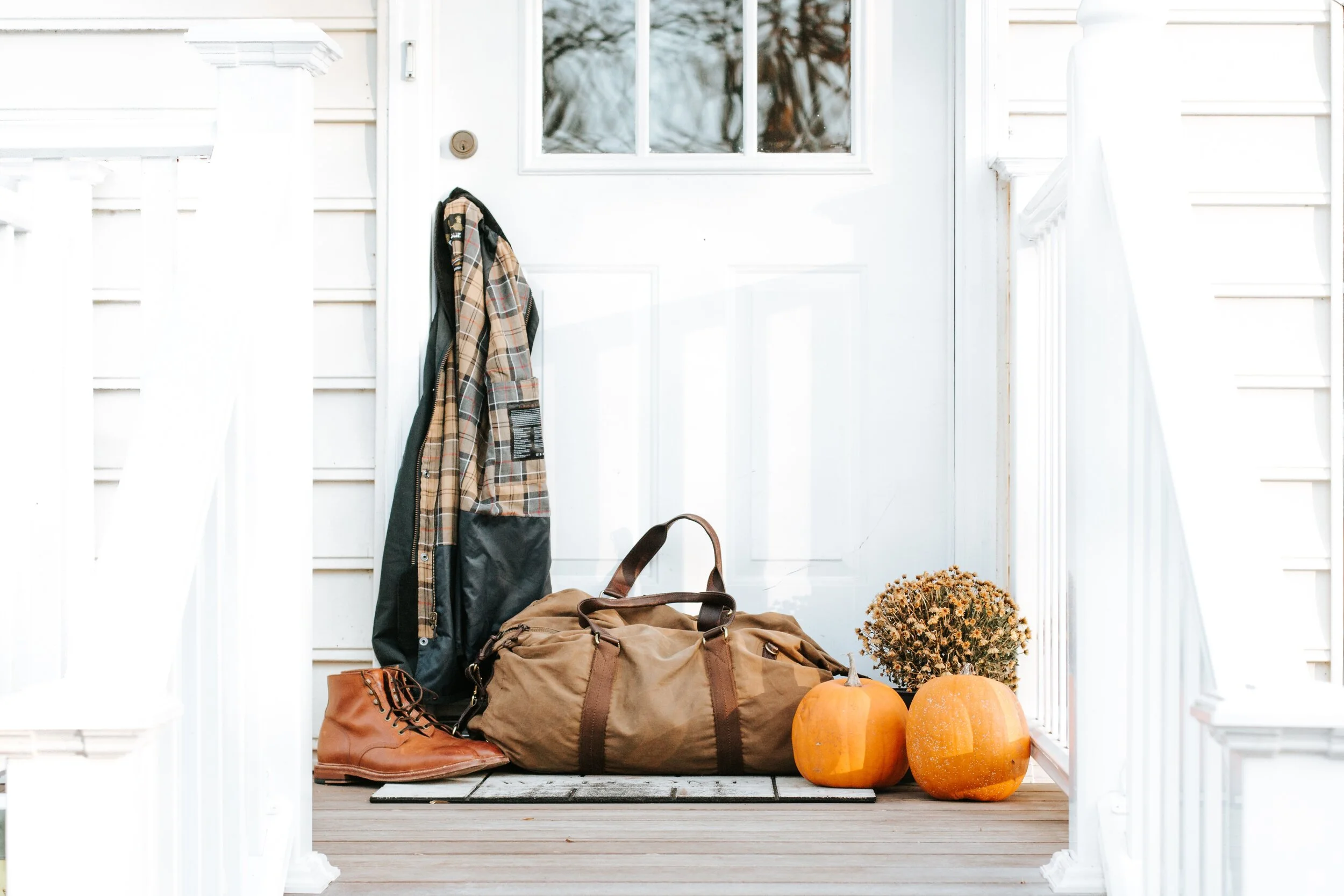 front door decorated with pumpkins