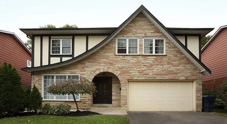 home with arched porched and two car garage