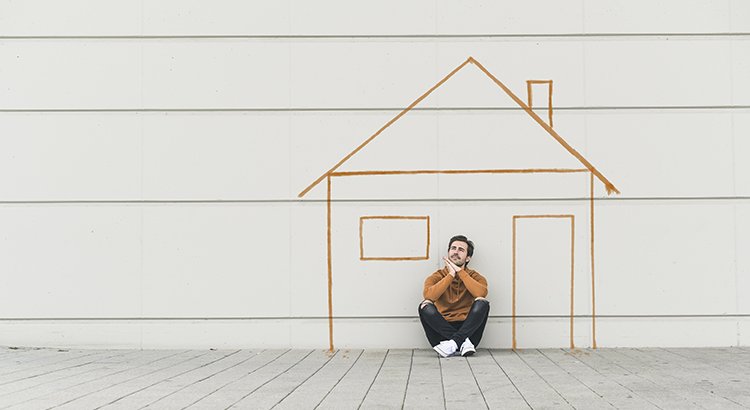 home buyer sitting in front of illustration of home