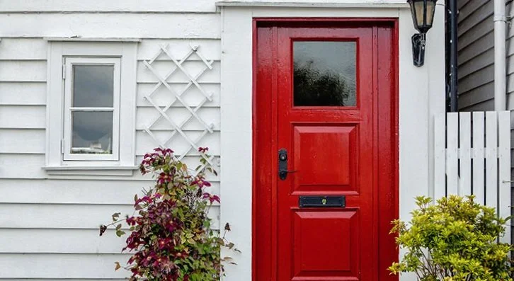 exterior of home showing front door and trellis