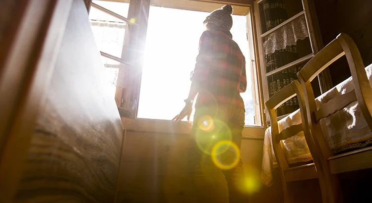 photo of person looking out the window