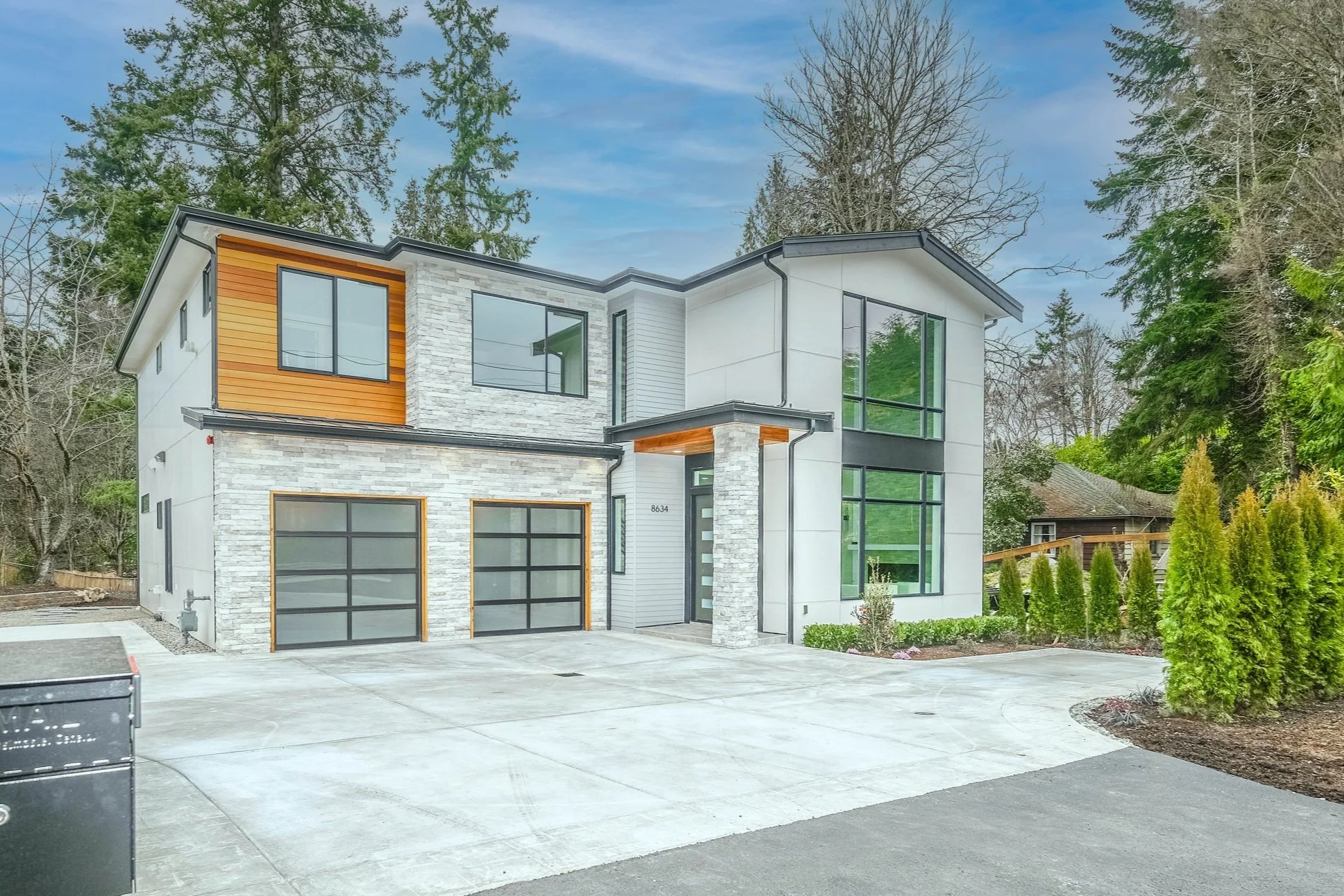 exterior of modern home with two car garage and large windows