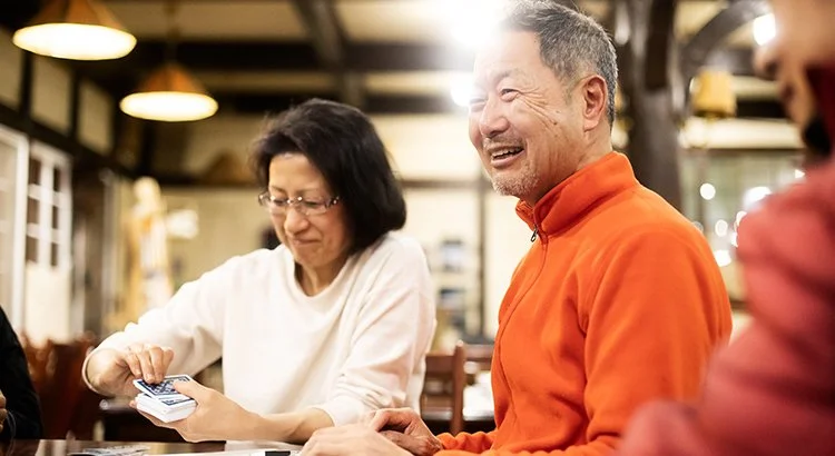 older couple playing cards