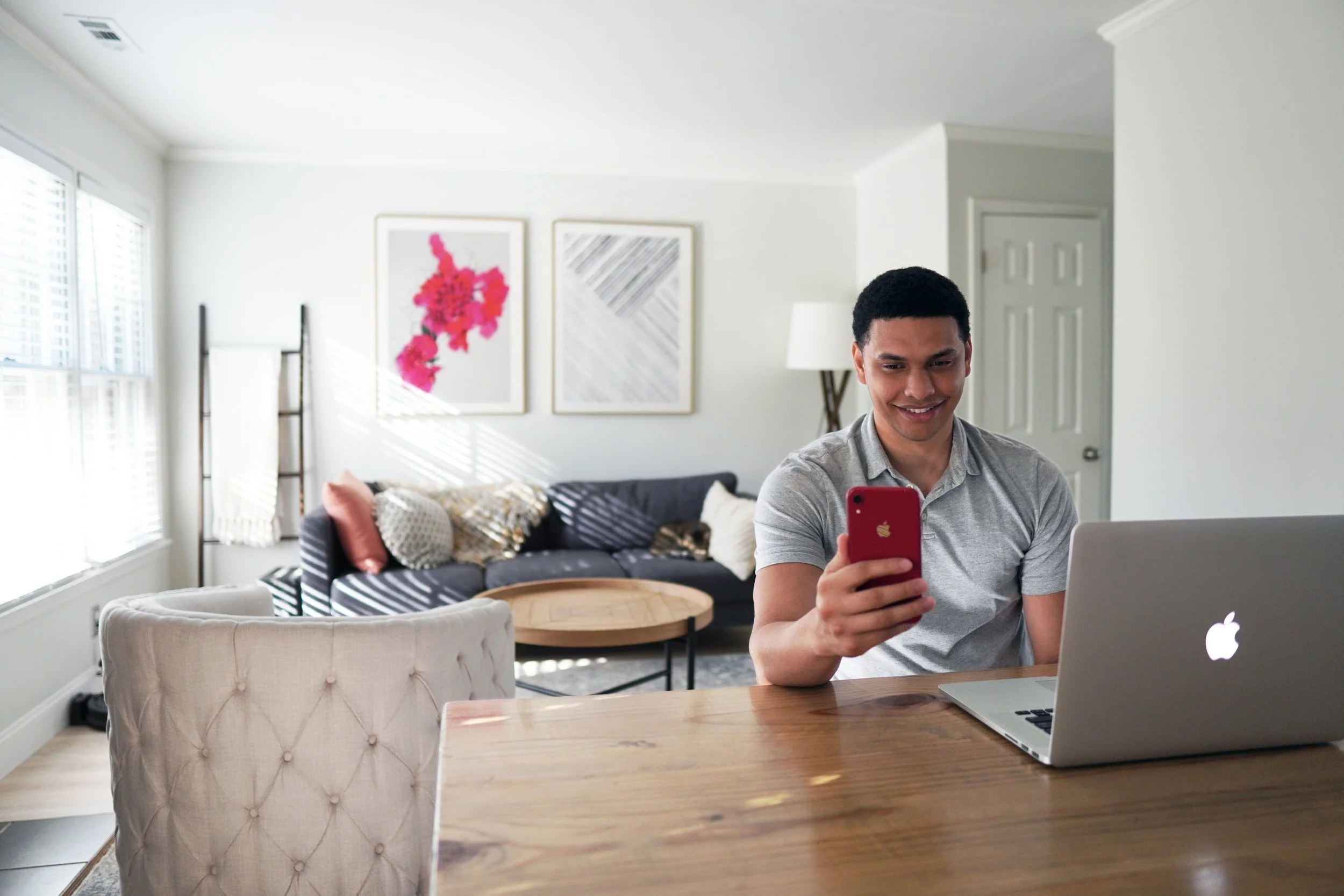 first time home buyer looking at phone in modern living room