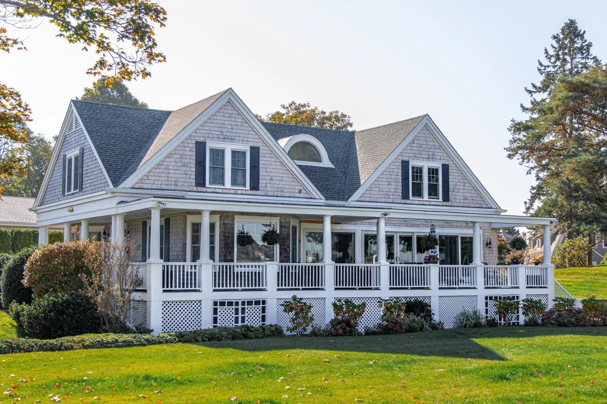 traditional style home with porch and green lawn